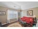 Inviting living room with a red sofa, window, and hardwood floors, creating a comfortable and stylish gathering area at 1907 Haven Park Se Cir, Smyrna, GA 30080