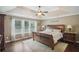 Serene main bedroom featuring a tray ceiling, plush bedding, and a wall of windows for natural light at 1907 Haven Park Se Cir, Smyrna, GA 30080