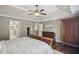 A spacious main bedroom featuring tray ceilings, a ceiling fan, and dark hardwood floors at 1907 Haven Park Se Cir, Smyrna, GA 30080