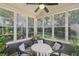 Bright sunroom with a ceiling fan, multiple windows, and a table with four chairs at 1907 Haven Park Se Cir, Smyrna, GA 30080