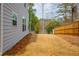 View of home's siding, and backyard, fenced in for privacy at 4700 Blake Loop, Atlanta, GA 30349