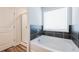 Bathroom featuring a bathtub, shower, and tiled accent at 4700 Blake Loop, Atlanta, GA 30349