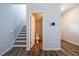 Entryway with staircase and half bathroom access, featuring wood-look flooring at 4700 Blake Loop, Atlanta, GA 30349