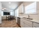 Bright kitchen with white cabinets and a view of the dining and living spaces at 4700 Blake Loop, Atlanta, GA 30349