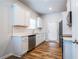 Well-lit kitchen featuring white cabinets, stainless steel appliances, and wood-look flooring at 4700 Blake Loop, Atlanta, GA 30349