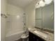 Bathroom featuring granite vanity countertop with a sink and a combined tub and shower at 8620 Blair Ct, Douglasville, GA 30134