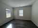 Bedroom with wood-look floors and two windows, offering plenty of natural light at 8620 Blair Ct, Douglasville, GA 30134