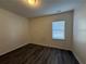 Cozy bedroom features wood-look flooring, white walls, and a window with blinds at 8620 Blair Ct, Douglasville, GA 30134