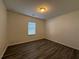 Bedroom with neutral paint, wood-look floors, and a window at 8620 Blair Ct, Douglasville, GA 30134