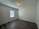 Bedroom with wood-look floors, neutral walls, and a window with blinds at 8620 Blair Ct, Douglasville, GA 30134