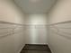 Empty walk-in closet with metal shelving and wood-look floors at 8620 Blair Ct, Douglasville, GA 30134