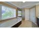 Bright bathroom features a soaking tub under a large window and a glass-enclosed shower at 251 Waterford Cove Dr, Suwanee, GA 30024