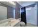 Bathroom with blue striped wallpaper, white fixtures, and a shower/tub combination at 251 Waterford Cove Dr, Suwanee, GA 30024