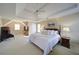 Spacious bedroom featuring a tray ceiling, ceiling fan, and large windows at 251 Waterford Cove Dr, Suwanee, GA 30024