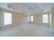 This bedroom has a large tray ceiling, three windows, and neutral carpet at 251 Waterford Cove Dr, Suwanee, GA 30024