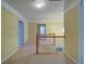 Upstairs hallway with carpet flooring, wood banister and natural lighting at 251 Waterford Cove Dr, Suwanee, GA 30024
