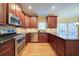 Well-appointed kitchen featuring updated appliances, stone backsplash, and wood cabinets at 251 Waterford Cove Dr, Suwanee, GA 30024