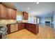 Modern kitchen featuring granite countertops, stainless steel appliances, and view of the living room at 251 Waterford Cove Dr, Suwanee, GA 30024