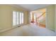 Cozy living room featuring neutral carpet, shuttered windows, and ample natural light at 251 Waterford Cove Dr, Suwanee, GA 30024
