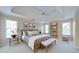 Inviting main bedroom boasts a tray ceiling, carpet, and natural light at 251 Waterford Cove Dr, Suwanee, GA 30024
