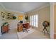 Bright home office with built-in shelves, a desk, and plantation shutters at 251 Waterford Cove Dr, Suwanee, GA 30024