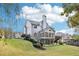 Manicured lawn leading to the house with a sunroom, deck, and patio at 2064 Democracy Dr, Buford, GA 30519