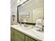 Bathroom vanity with marbled top, designer mirror, and olive green cabinetry at 2064 Democracy Dr, Buford, GA 30519