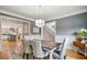 Elegant dining room featuring a modern chandelier, wainscoting, and hardwood floors at 2064 Democracy Dr, Buford, GA 30519