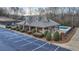 Community clubhouse with tennis courts, pool, and manicured landscaping at 2064 Democracy Dr, Buford, GA 30519