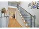 Inviting foyer with hardwood floors and elegant staircase with wrought iron spindles at 2064 Democracy Dr, Buford, GA 30519