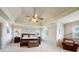 Spacious main bedroom featuring a tray ceiling, a ceiling fan, and ample natural light at 2064 Democracy Dr, Buford, GA 30519