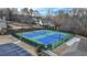 Aerial view of community tennis courts, adjacent to parking and landscaped grounds at 2064 Democracy Dr, Buford, GA 30519