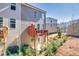 View of a multi-level backyard with a wood deck above a patio area of a gray townhome at 399 Skylar Se Way, Atlanta, GA 30315