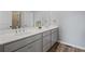 Bathroom featuring a double vanity with grey cabinets, white countertop, and wood-look floors at 399 Skylar Se Way, Atlanta, GA 30315