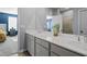 Bright bathroom features a double sink vanity with white countertop and framed mirror at 399 Skylar Se Way, Atlanta, GA 30315