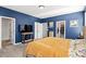 Bedroom featuring blue walls, carpet, and a bed with floral patterned sheets and headboard at 399 Skylar Se Way, Atlanta, GA 30315