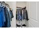 Walk-in closet with hanging clothes and storage baskets at 399 Skylar Se Way, Atlanta, GA 30315