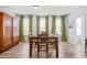 Dining area features a wood table with seating for four, green curtains and wood flooring at 399 Skylar Se Way, Atlanta, GA 30315