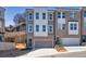 New townhouse showcases a two-car garage and brick facade, complemented by a lush, landscaped setting at 399 Skylar Se Way, Atlanta, GA 30315