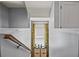 Hallway featuring yellow patterned curtains and wooden railing at 399 Skylar Se Way, Atlanta, GA 30315