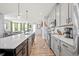 Modern kitchen featuring an island and stainless steel appliances, seamlessly connected to the living area at 399 Skylar Se Way, Atlanta, GA 30315