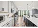 Modern kitchen with stainless steel appliances, a long island with barstool seating, and white countertops at 399 Skylar Se Way, Atlanta, GA 30315