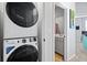 Modern stacked washer and dryer next to powder room at 399 Skylar Se Way, Atlanta, GA 30315