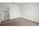 Spacious bedroom with neutral carpet, white walls, closet, and access to bathroom through a doorway at 525 Parkway Dr Ne # 203, Atlanta, GA 30354