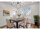 Dining area featuring a modern light fixture, large windows, a dining table set for six, and indoor plants at 525 Parkway Dr Ne # 203, Atlanta, GA 30354