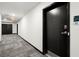 Hallway in apartment building featuring unit door, carpet flooring, and exit sign at 525 Parkway Dr Ne # 203, Atlanta, GA 30354