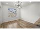 Open living room with modern lighting, light wood floors, a large window, and natural light at 525 Parkway Dr Ne # 203, Atlanta, GA 30354