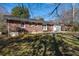 View of the home's backyard with brick and siding exterior, and a concrete patio at 1523 Vancouver Dr, Tucker, GA 30084