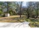 Expansive backyard featuring a shed, mature trees, and a partially visible concrete patio at 1523 Vancouver Dr, Tucker, GA 30084