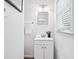 Bathroom featuring white vanity with sink and a window with blinds for natural light at 1523 Vancouver Dr, Tucker, GA 30084